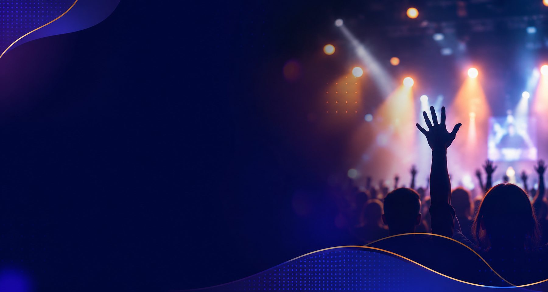 Crowd with raised hands at a concert under stage lights