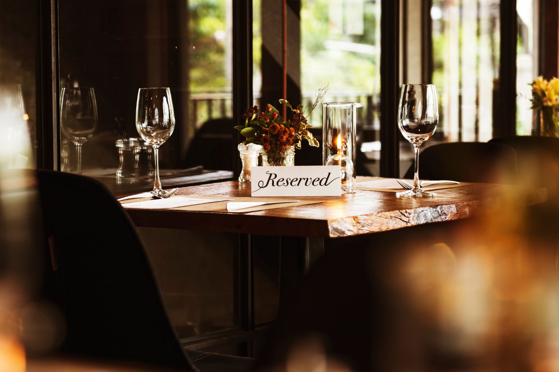 Candlelit restaurant table set for dinner